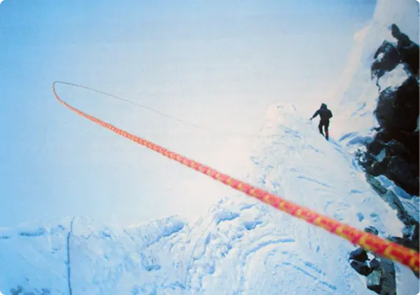 A man looking up to a snowy mountain peak in the distance