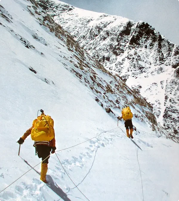 Two climbers scaling a mountain